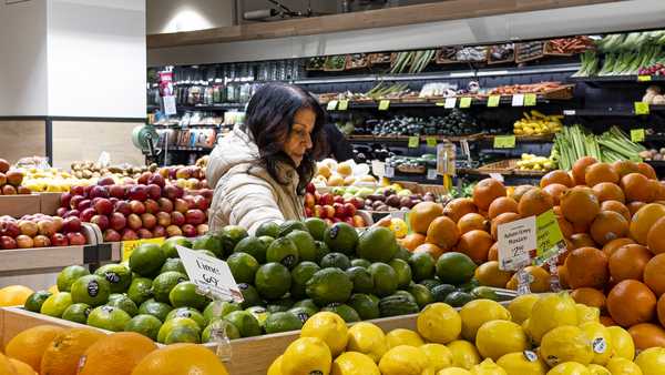 A woman browses produce for sale at a grocery store, Friday, Jan. 19, 2024, in New York.
