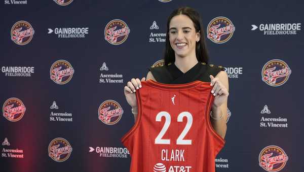 Indiana Fever's Caitlin Clark holds her jersey following a WNBA basketball news conference, Wednesday, April 17, 2024, in Indianapolis. (AP Photo/Darron Cummings)