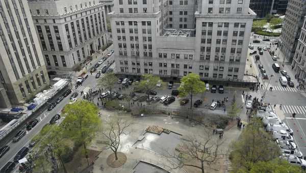 White fire extinguisher residue marks the spot in Collect Pond Park where a man lit himself on fire outside Manhattan criminal court, Friday, April 19, 2024, in New York. Emergency crews rushed away a person on a stretcher after fire was extinguished outside the Manhattan courthouse where jury selection was taking place in former President Donald Trump's hush money criminal case. (AP Photo/Mary Altaffer)