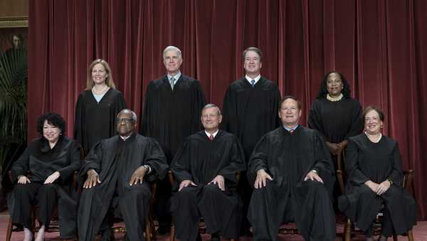 Members of the Supreme Court sit for a new group portrait following the addition of Associate Justice Ketanji Brown Jackson, at the Supreme Court building in Washington, on Oct. 7, 2022.