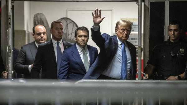 Former President Donald Trump waves to the media as he returns from a break during his trial at Manhattan criminal court , Friday, April 26, 2024, in New York.