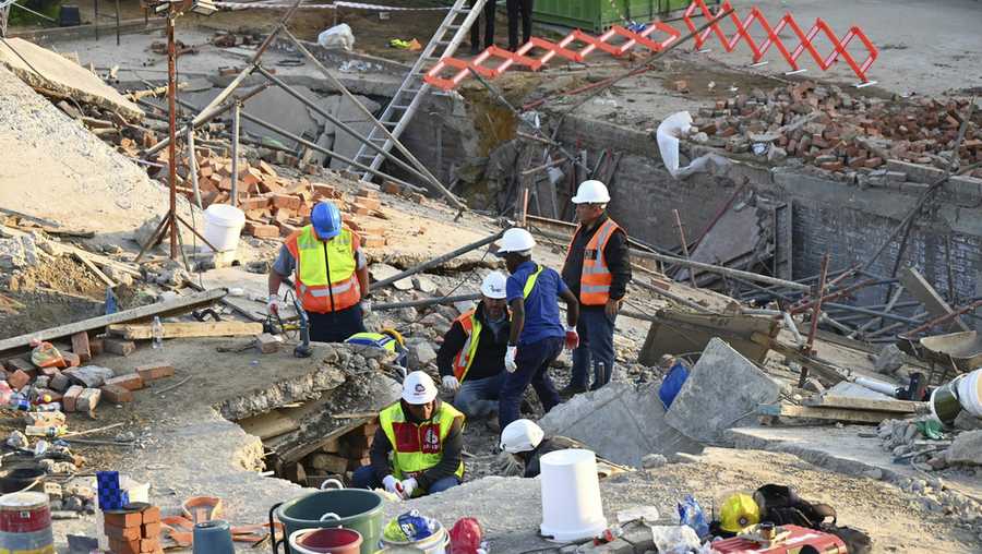 Emergency workers on the scene of a collapsed building in George, South Africa, Tuesday, May 7, 2024.