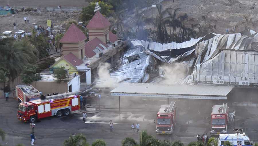 Firefighters douse a fire which broke out in a fun park, in Rajkot in the Indian state of Gujarat, Saturday, May 25, 2024. A massive fire broke out on Saturday in a fun park in western India, killing more than ten people and injuring some others, news reports said. (AP Photo/Chirag Chotaliya)