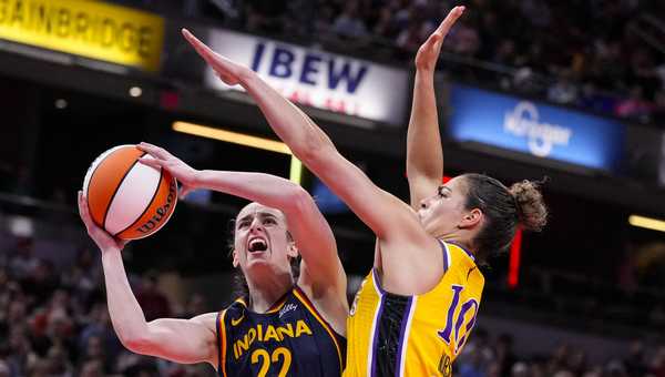 Indiana Fever guard Caitlin Clark (22) shoots around Los Angeles Sparks guard Kia Nurse (10) in the first half of a WNBA basketball game in Indianapolis, Tuesday, May 28, 2024. (AP Photo/Michael Conroy)