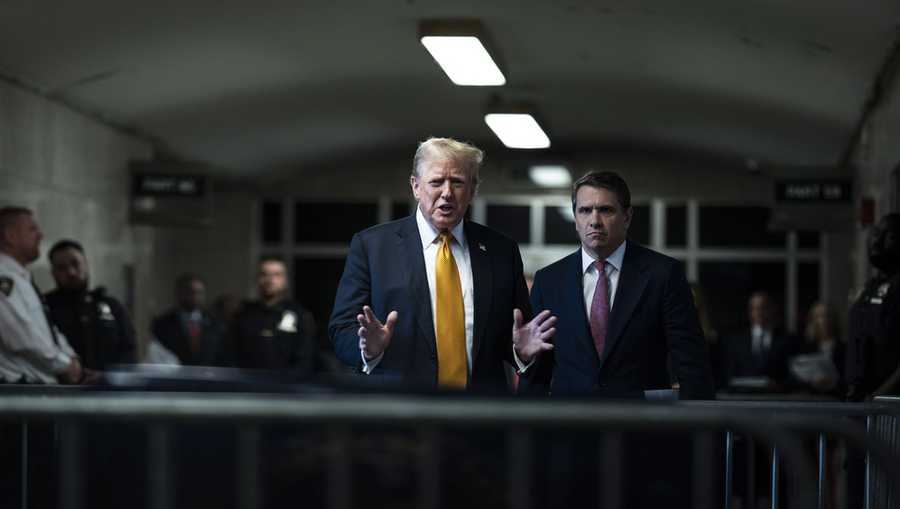 Former President Donald Trump speak to reporters, with his attorney, Todd Blanche, right, as jurors begin deliberations for his trial at the Manhattan criminal court, Wednesday, May 29, 2024, in New York.