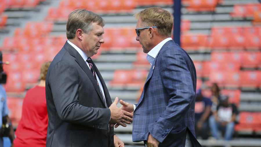 Georgia head coach Kirby Smart, left, shakes hands with Auburn football head coach Hugh Freeze on the field prior to an NCAA football game on Saturday, Sept. 30, 2023, in Auburn, Ala. (AP Photo/Stew Milne)