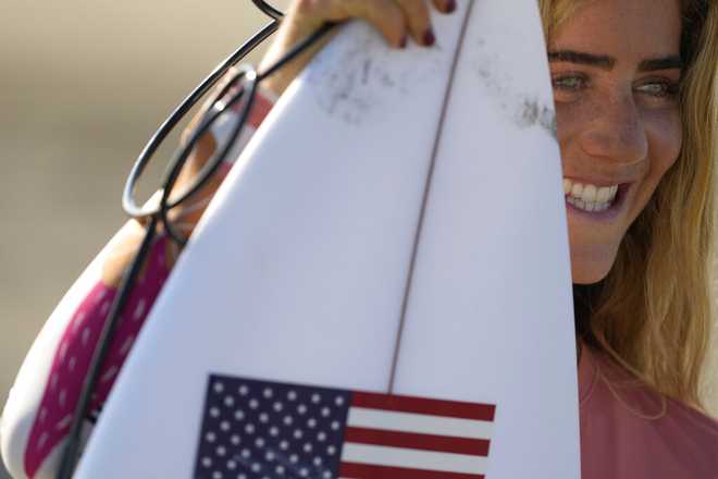 Caroline Marks, of the United States, poses for a photo before a training session at the 2020 Summer Olympics, Saturday, July 24, 2021, at Tsurigasaki beach in Ichinomiya, Japan. (AP Photo/Francisco Seco)