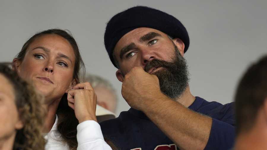Recently retired Philadelphia Eagles lineman Jason Kelce and wife Kylie watch the women's field hockey match between the Argentina and United States, at the Yves-du-Manoir Stadium, at the 2024 Summer Olympics, Saturday, July 27, 2024, in Colombes, France. (AP Photo/Anjum Naveed)