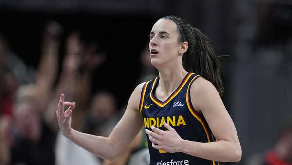 Indiana Fever's Caitlin Clark reacts after hitting a shot during the second half of a WNBA basketball game against the Seattle Storm, Sunday, Aug. 18, 2024, in Indianapolis. (AP Photo/Darron Cummings)