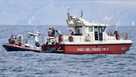 Italian Firefighters scuba divers bring ashore in a green bag the body of one of the victims of the UK flag vessel Bayesian, Wednesday, Aug. 21, 2024. 