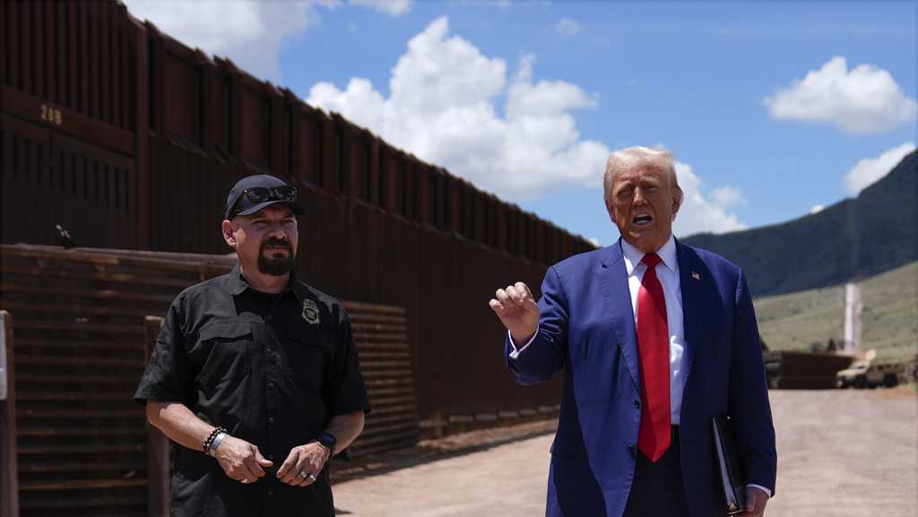 Trump uses a stretch of border wall and a pile of steel beams in ...