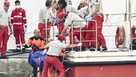 Italian firefighter divers bring ashore in a plastic bag the body of one of the victims of a shipwreck, in Porticello, Sicily, southern Italy, Thursday, Aug. 22, 2024.