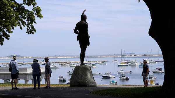 FILE - Visitors stand near a 1921 statue of the Wampanoag leader Massasoit, center, Wednesday, June 9, 2021, on Cole's Hill, in Plymouth, Mass. The town of Plymouth announced Friday, Aug. 23, 2024, that it's closing public outdoor recreation facilities from dusk until dawn each day after a horse in the town was infected with eastern equine encephalitis. (AP Photo/Steven Senne, File)