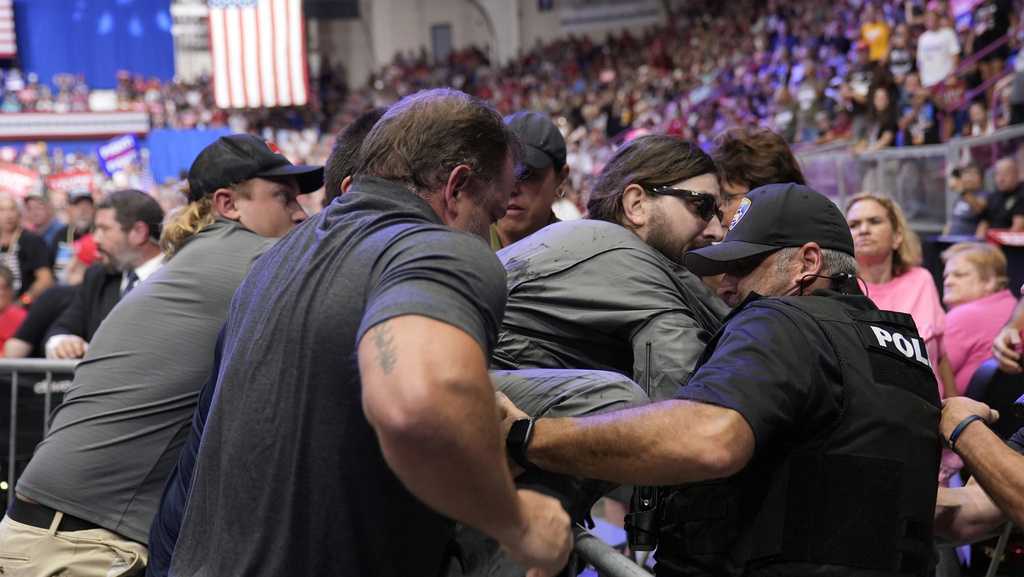 Police say a man will face charges after storming into the press area at a Trump rally