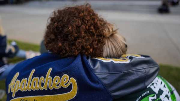 Mourners listen to a speaker during a candlelight vigil for the slain students and teachers at Apalachee High School, Wednesday, Sept. 4, 2024, in Winder, Ga.