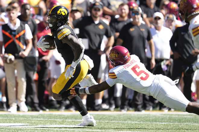 Iowa&#x20;running&#x20;back&#x20;Kaleb&#x20;Johnson&#x20;&#x28;2&#x29;&#x20;runs&#x20;from&#x20;Iowa&#x20;State&#x20;defensive&#x20;back&#x20;Myles&#x20;Purchase&#x20;&#x28;5&#x29;&#x20;during&#x20;a&#x20;27-yard&#x20;touchdown&#x20;run&#x20;in&#x20;the&#x20;first&#x20;half&#x20;of&#x20;an&#x20;NCAA&#x20;college&#x20;football&#x20;game,&#x20;Saturday,&#x20;Sept.&#x20;7,&#x20;2024,&#x20;in&#x20;Iowa&#x20;City,&#x20;Iowa.&#x20;&#x28;AP&#x20;Photo&#x2F;Charlie&#x20;Neibergall&#x29;