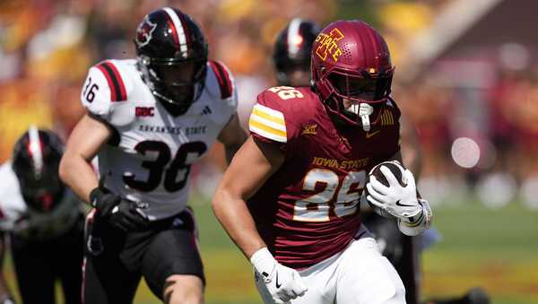 Iowa State running back Carson Hansen (26) runs from Arkansas State linebacker Charles Willekes (36) during the first half of an NCAA college football game, Saturday, Sept. 21, 2024, in Ames, Iowa. (AP Photo/Charlie Neibergall)