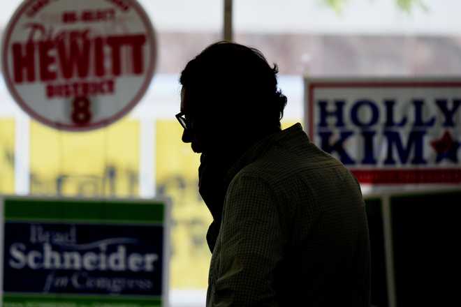 Matt Muchowkshi, chair of the Waukegan Township Democrats, looks around at the Waukegan Township Democrats office in Waukegan, Ill., Monday, Sept. 16, 2024. (AP Photo/Nam Y. Huh)