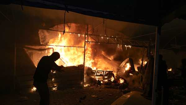 Palestinians react to a fire after an Israeli strike hit a tent area in the courtyard of Al Aqsa Martyrs hospital in Deir al Balah, Gaza Strip, Monday, Oct. 14, 2024.