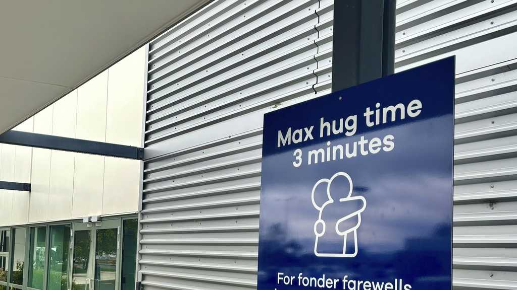 New Zealand airport puts three-minute limit on goodbye hugs