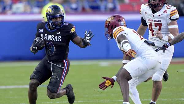 Kansas running back Daniel Hishaw Jr. (9) gets past Iowa State defensive back Ta'Shawn James during the first half of an NCAA college football game Saturday, Nov. 9, 2024, in Kansas City, Mo. (AP Photo/Charlie Riedel)