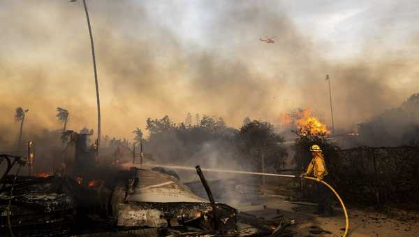 Firefighters work against the Mountain Fire, Nov. 6, 2024, near Camarillo, Calif. (AP Photo/Ethan Swope)