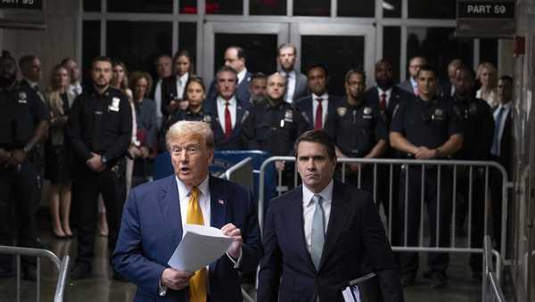 Former President Donald Trump, standing with defense attorney Todd Blanche, speaks at the conclusion of proceedings for the day at his trial at Manhattan criminal court, Tuesday, May 14, 2024, in New York.