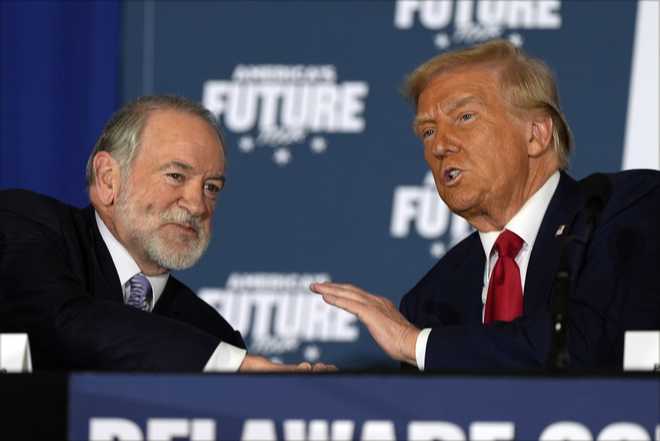 Republican presidential nominee former President Donald Trump talks with former Arkansas Gov. Mike Huckabee during a roundtable at the Drexelbrook Catering &amp; Event Center, Tuesday, Oct. 29, 2024, in Drexel Hill, Pa. (AP Photo/Julia Demaree Nikhinson)