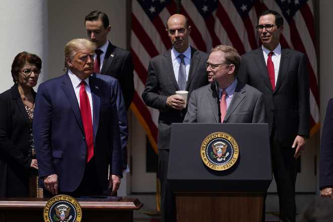 FILE - White House senior adviser Kevin Hassett speaks as President Donald Trump and others listen during a news conference in the Rose Garden of the White House, June 5, 2020, in Washington. (AP Photo/Evan Vucci, File)