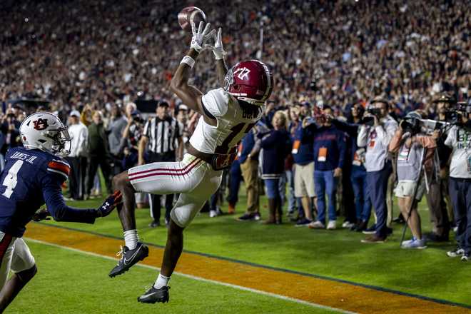 Alabama wide receiver Isaiah Bond (17) catches a touchdown pass on a fourth-and-long play in the final minute, securing a victory over Auburn in the second half of an NCAA college football game, Saturday, Nov. 25, 2023 , in Auburn, Ala. (AP Photo/Vasha Hunt)