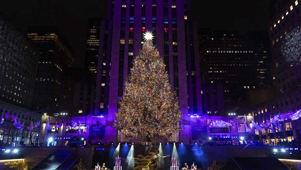 Fifty-thousand multi-colored lights are shining on Rockefeller Heart’s iconic Christmas tree, with crowds gathering to witness the annual New York Metropolis custom