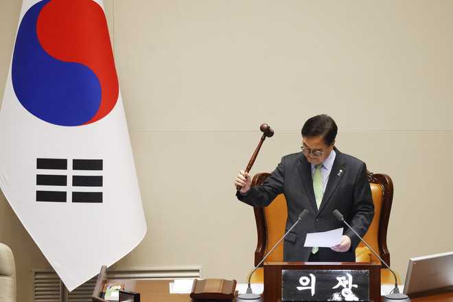 South Korean National Assembly Speaker Woo Won-shik announces bangs the gavel to announce that &quot;the voting cannot take place&quot; because the quorum was not reached during a plenary session for the impeachment vote of South Korean President Yoon Suk Yeol is set to take place at the National Assembly in Seoul, South Korea, Saturday, Dec. 7, 2024. (Jeon Heon-kyun/Pool Photo via AP)