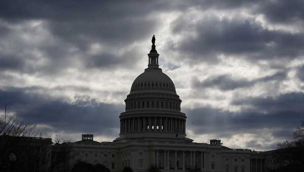 FILE - The Capitol in Washington, is framed by early morning clouds, March 19, 2024. Congress has until midnight Friday to come up with a way to fund the government, or federal agencies will shutter. It's up to each federal agency to determine how it handles a shutdown, but there would be disruptions in many services. (AP Photo/J. Scott Applewhite, File)