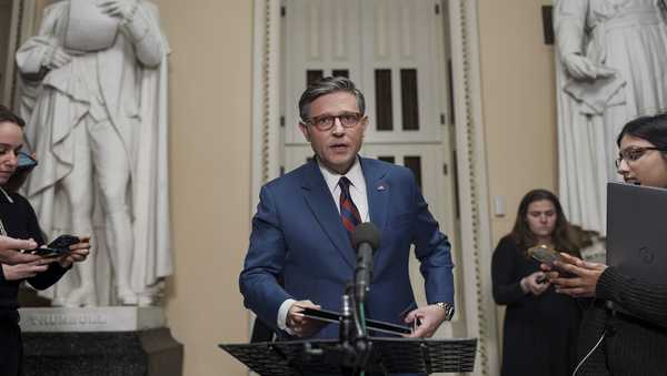 Speaker of the House Mike Johnson, R-La., talks briefly to reporters just before a vote on an interim spending bill to prevent a government shutdown, at the Capitol in Washington, Thursday, Dec. 19, 2024. (AP Photo/J. Scott Applewhite)