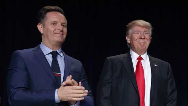 FILE - Television producer Mark Burnett, left, looks on as President Donald Trump arrives for the National Prayer Breakfast, Feb. 2, 2017, in Washington. (AP Photo/Evan Vucci, File)