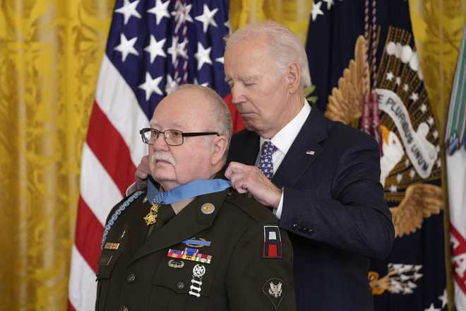 President Joe Biden presents the Medal of Honor, the nation&apos;s highest military decoration, to then-Private First Class Kenneth J. David, during a ceremony in the East Room of the White House in Washington, Friday, Jan. 3, 2025. (AP Photo/Susan Walsh)