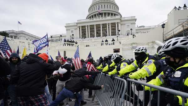 FILE - Insurrectionists loyal to President Donald Trump try to break through a police barrier, Wednesday, Jan. 6, 2021, at the Capitol in Washington. (AP Photo/Julio Cortez, File)