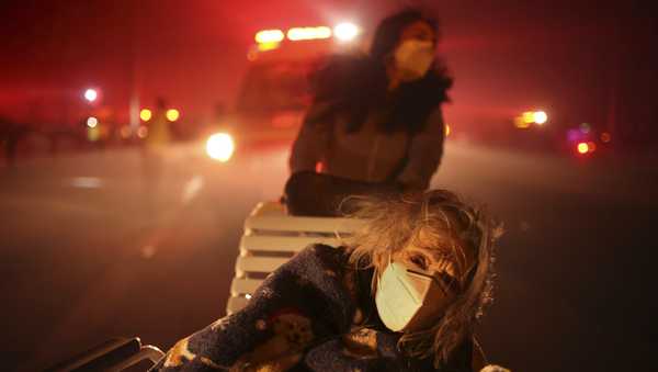 A resident of a senior center is evacuated as the Eaton Fire approaches Tuesday, Jan. 7, 2025 in Altadena, Calif.