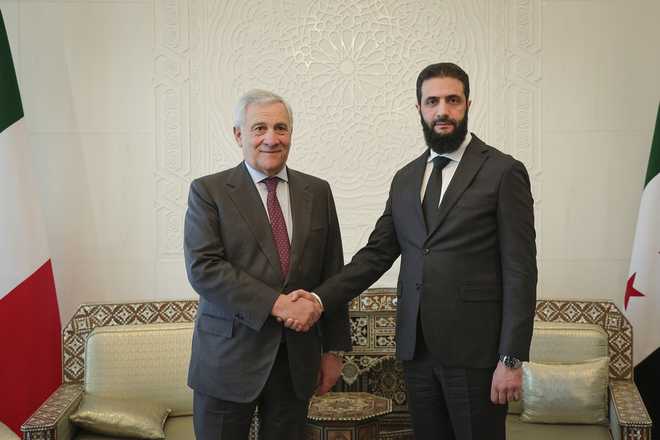 In this photo released by the Syrian official news agency SANA, Syria&apos;s de facto leader Ahmad al-Sharaa, formerly known as Abu Mohammed al-Golani, right, meets with Italian foreign minister Antonio Tajani in Damascus, Syria, Friday, Jan. 10, 2025. (SANA via AP)