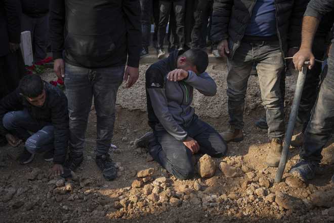 Mourners react next to the grave of 23-year-old hostage Hamzah AlZayadni during his funeral in the Bedouin city of Rahat, southern Israel, Friday, Jan. 10, 2025. AlZayadni was in Hamas captivity in the Gaza Strip. Israel&apos;s army said his body was recovered in an underground tunnel in southern Gaza. (AP Photo/Ariel Schalit)