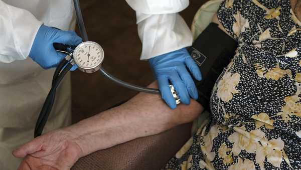 FILE - A doctor checks the blood pressure of A 94-year-old woman in Sant Sadurní d'Anoia, Catalonia region, Spain, Friday, July 31, 2020. (AP Photo/Felipe Dana, File)