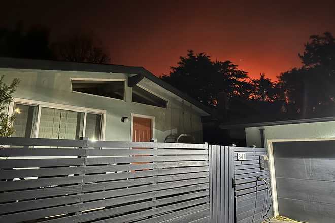 The home of Ryan Pearson, a Los Angeles-based entertainment video editor for The Associated Press, in Altadena, California, is seen as he and his family evacuate due to the Eaton Fire, Tuesday, Jan. 7, 2025.