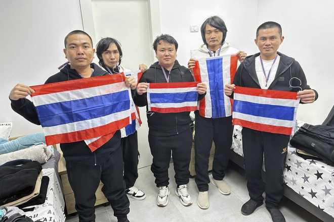 Thai hostages who were freed from Hamas, from left to right, Surasak Rumnao, Sathian Suwannakham, Bannawat Saethao, Watchara Sriaoun, and Pongsak Thaenna hold the Thailand flag in Israel, Thursday, Jan. 30, 2025.