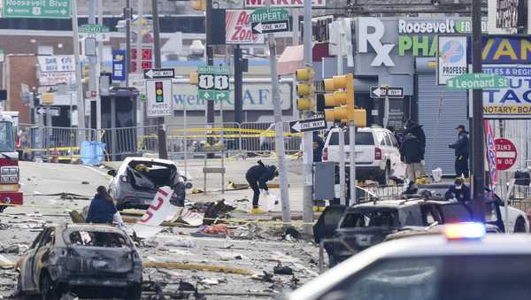 Investigators work the scene after a small plane crashed in Philadelphia, Saturday, Feb. 1, 2025. (AP Photo/Matt Rourke)