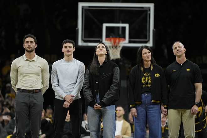 Former&#x20;Iowa&#x20;guard&#x20;and&#x20;current&#x20;Indiana&#x20;Fever&#x20;WNBA&#x20;player&#x20;Caitlin&#x20;Clark,&#x20;center,&#x20;stands&#x20;with&#x20;family&#x20;members&#x20;during&#x20;her&#x20;jersey&#x20;retirement&#x20;ceremony&#x20;after&#x20;an&#x20;NCAA&#x20;college&#x20;basketball&#x20;game&#x20;between&#x20;Iowa&#x20;and&#x20;Southern&#x20;California,&#x20;Sunday,&#x20;Feb.&#x20;2,&#x20;2025,&#x20;in&#x20;Iowa&#x20;City,&#x20;Iowa.&#x20;&#x28;AP&#x20;Photo&#x2F;Charlie&#x20;Neibergall&#x29;
