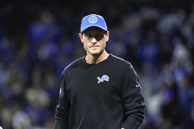 Detroit Lions offensive coordinator Ben Johnson watches during warmups before an NFL football divisional playoff game against the Washington Commanders, Saturday, Jan. 18, 2025, in Detroit. (AP Photo/Rey Del Rio)