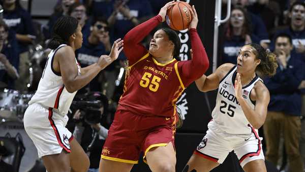 Iowa State center Audi Crooks is guarded by UConn forwards Sarah Strong, left, and Ice Brady, right, in the first half of an NCAA college basketball game, Tuesday, Dec. 17, 2024, in Uncasville, Conn. (AP Photo/Jessica Hill)