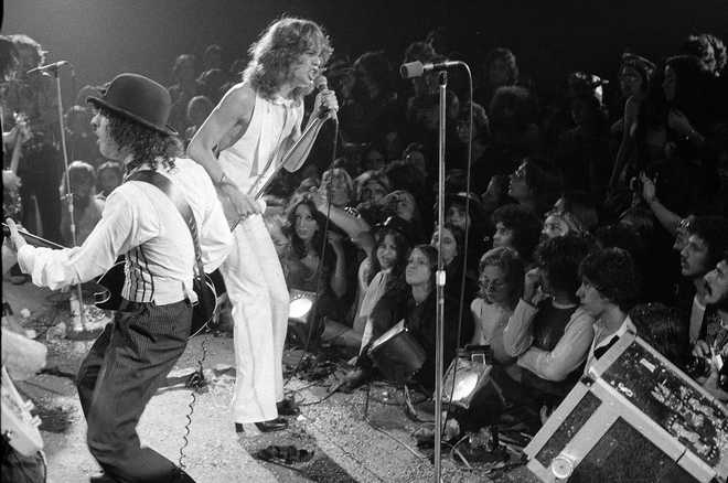 FILE - Rock group &quot;The New York Dolls&quot; perform at the Waldorf Halloween Ball, Waldorf-Astoria Hotel, NYC, Oct. 31, 1973. At right is lead singer David Johansen, with guitarist Sylvain Sylvain. (AP Photo/Richard Drew, File)