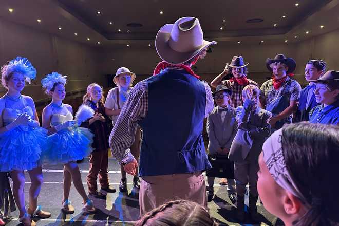 Callum Ganz, 17, center, gives a pre-show pep talk to castmates in Crazy for You on opening night as the Theatre Palisades Youth group returns to the stage after losing their theater in the Palisades fire, in Los Angeles, Feb. 28, 2025. (AP Photo/ Jocelyn Gecker)