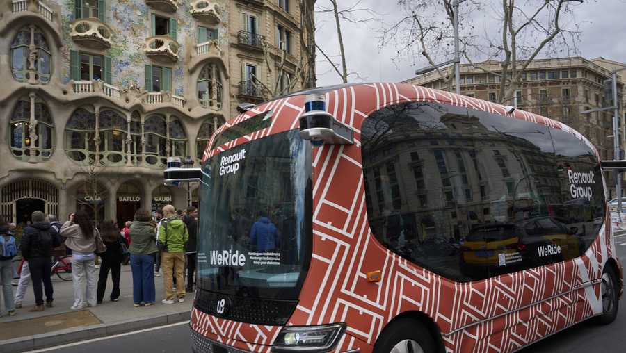 A driverless minibus, presented by WeRide and Renault Group, goes by Casa Batllo in downtown Barcelona on Wednesday, March 12, 2025.
